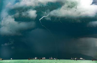 Scenic view of sea against storm clouds in sky