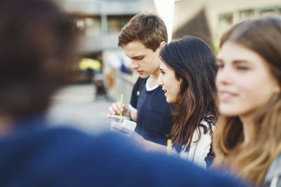 Teenagers standing on bridge outdoors