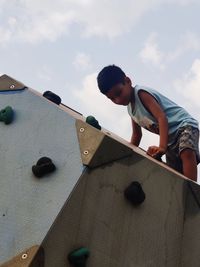 Low angle view of boy playing with toy blocks