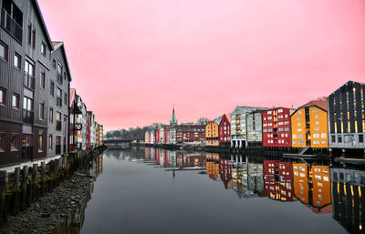 Canal amidst buildings against sky in city