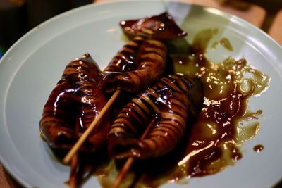 High angle view of food in plate. japanese bbq squid in a brown sauce.