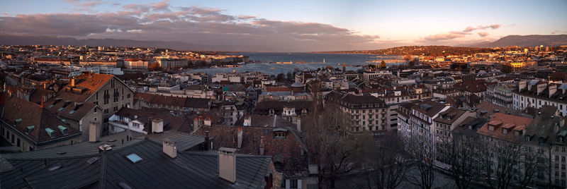 High angle view of townscape by sea against sky