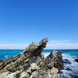 Scenic view of sea against clear blue sky