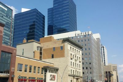 Low angle view of modern buildings against clear blue sky