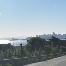 Bridge over river with cityscape in background