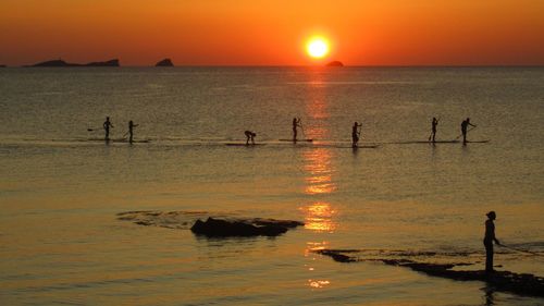 Scenic view of sea against orange sky