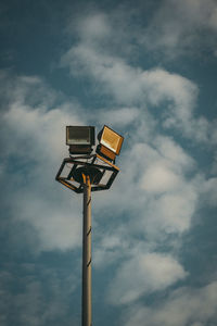 Low angle view of illuminated street light against sky