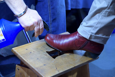 Close-up of man hand on wood