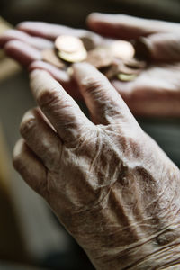 Senior woman's hands with coins