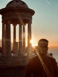 Rear view of man against sky during sunset