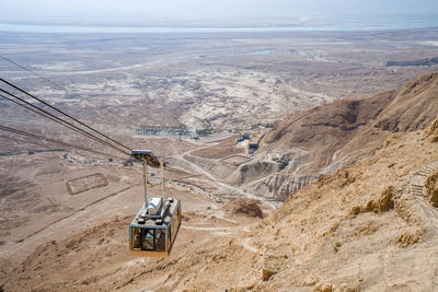 Cable car ride to masada fortress rock plateau in israel on a sunny day