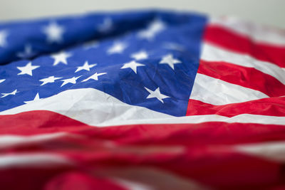 Close-up of flag against blue wall