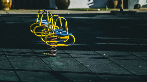 Close-up of yellow bicycle on street