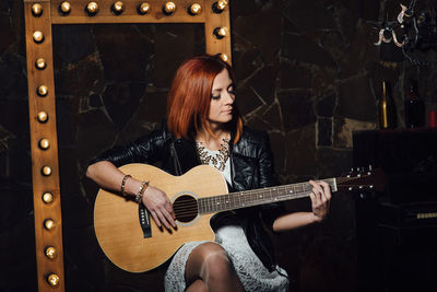 Young woman playing guitar