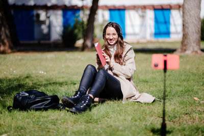 Young woman sitting on field