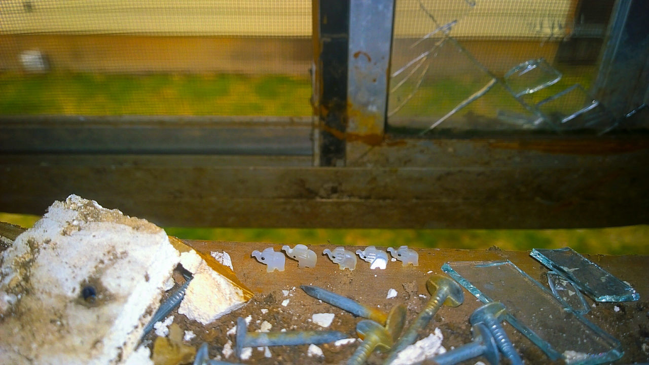 CLOSE-UP OF CIGARETTE ON GLASS WINDOW WITH REFLECTION