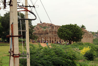 Group of people in front of built structure against sky