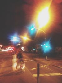 Road passing through illuminated city at night