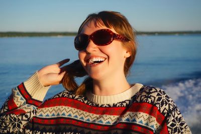 Portrait of smiling young woman at beach