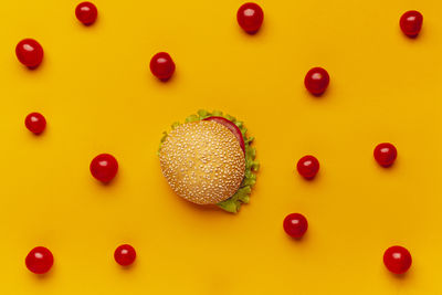 Directly above shot of multi colored candies on yellow background