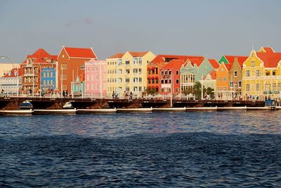 Boats in city against clear sky