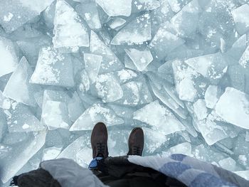 Low section of man standing on snow