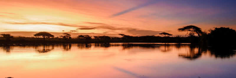 Scenic view of lake against sky during sunset