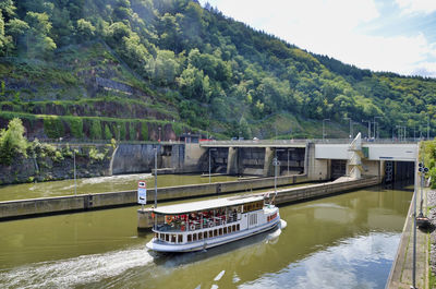 High angle view of train on river by trees