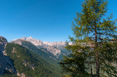 Scenic view of mountains against clear blue sky