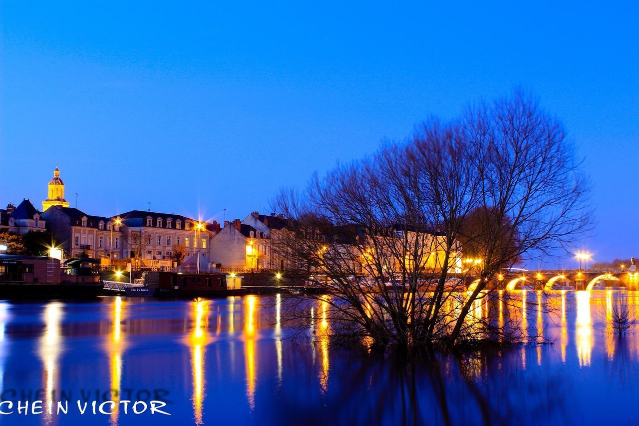 REFLECTION OF BUILDINGS IN RIVER