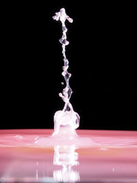 Close-up of water splashing over black background