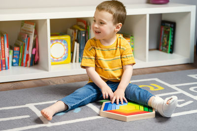 Portrait of boy sitting on floor