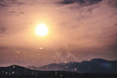 Scenic view of silhouette mountains against sky during sunset