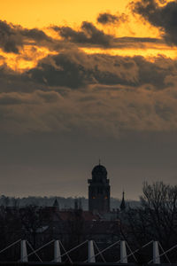 Buildings in city against sky during sunset