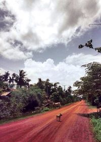 Empty road against cloudy sky