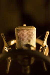 Close-up of microphone against black background