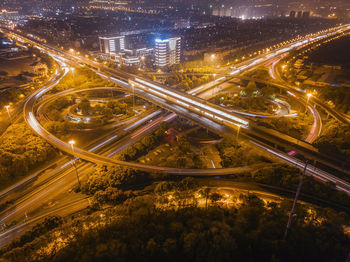 High angle view of light trails on road at night