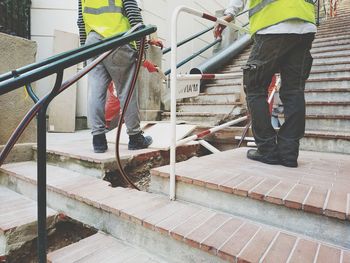 Low section of people working on staircase