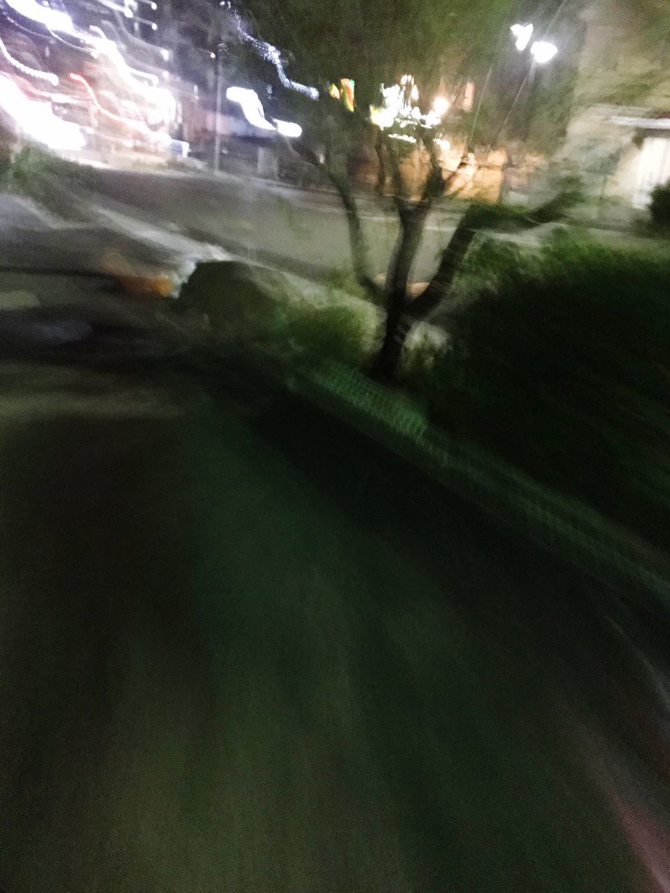 AERIAL VIEW OF ILLUMINATED STREET SEEN THROUGH WINDOW