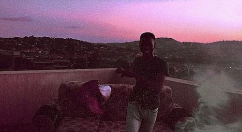 Rear view of silhouette man standing against mountain at sunset