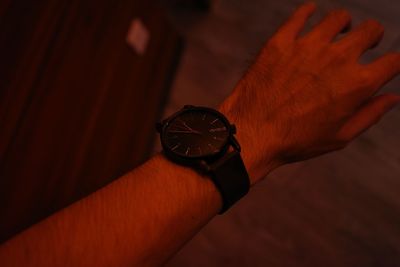 Close-up of hand holding clock