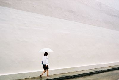 Rear view of man walking on floor