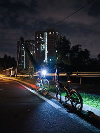 Bicycles on road in city at night