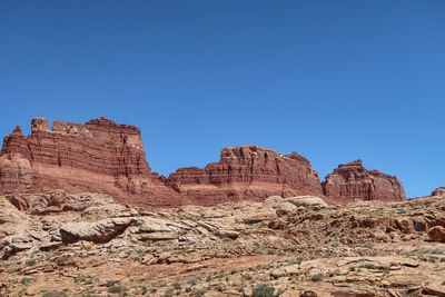 Rock formations against clear blue sky