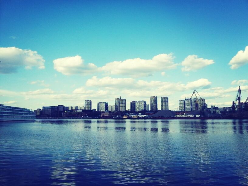 water, architecture, building exterior, waterfront, built structure, city, sky, river, blue, cityscape, urban skyline, skyscraper, cloud, cloud - sky, sea, reflection, skyline, harbor, mid distance, no people