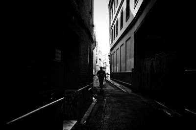 Woman walking in corridor of building