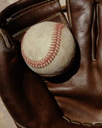 Close-up of baseball on gloves