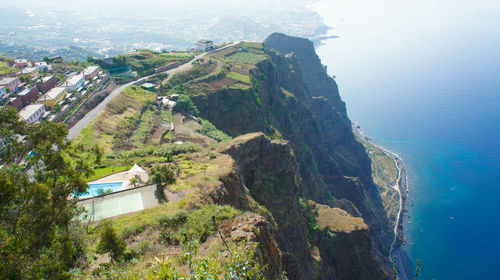 High angle view of sea and mountains against sky