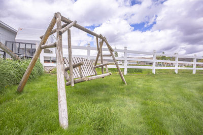 Metallic structure on field against sky