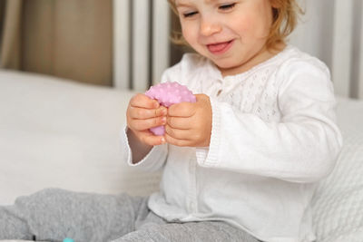 Baby girl playing tactile knobby balls. young child hand plays sensory massage ball